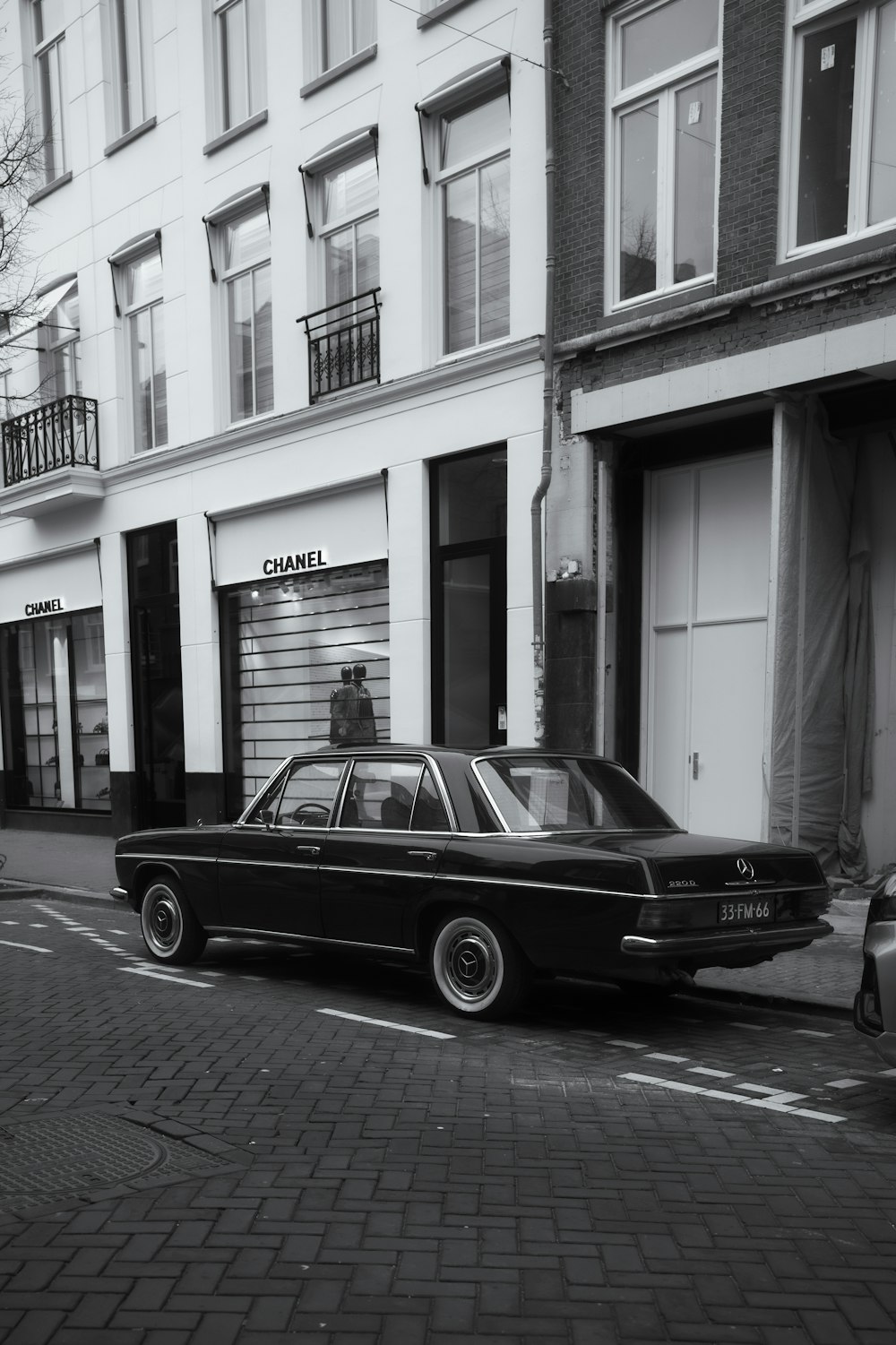 a black car parked on the side of a street