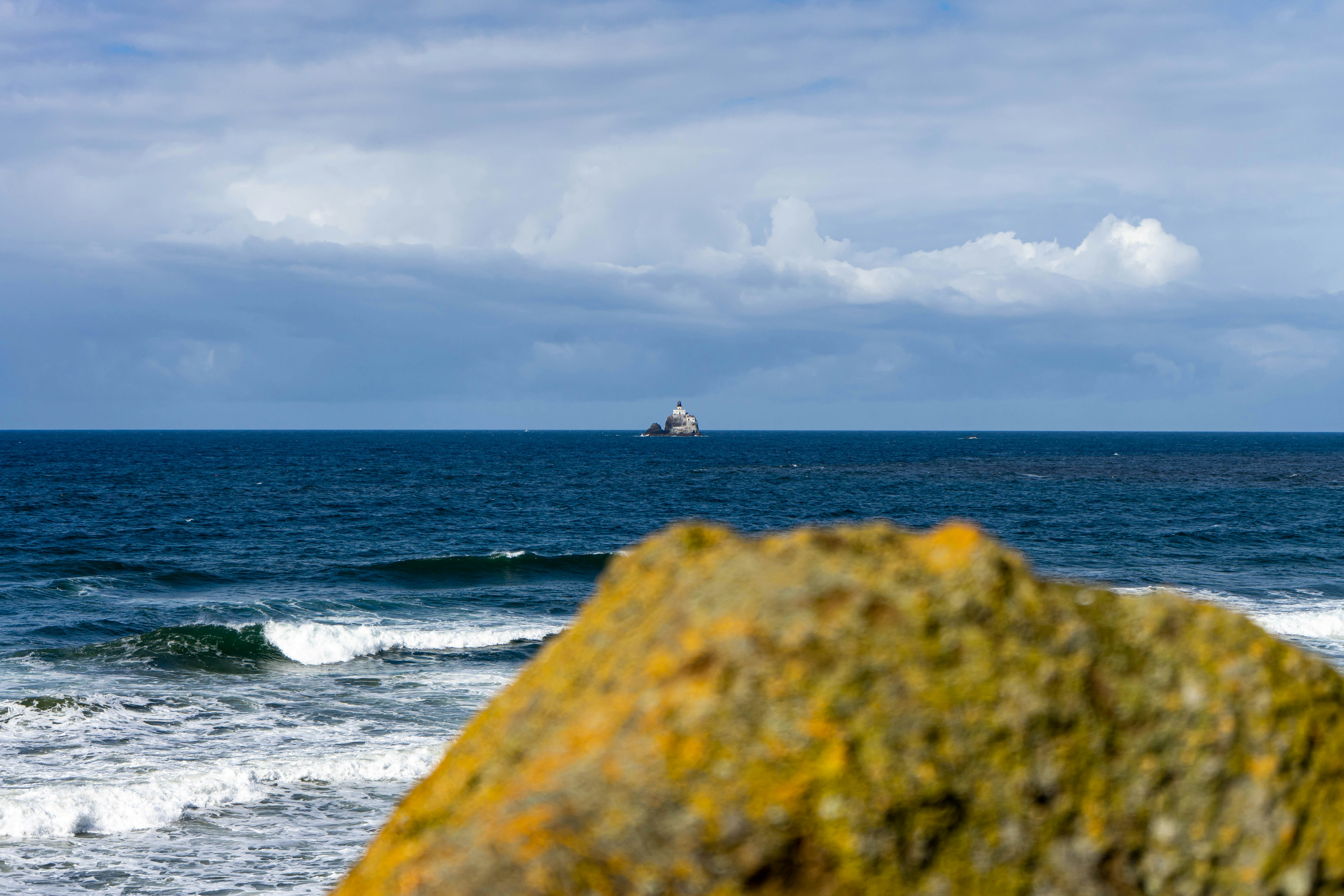a boat out in the ocean on a cloudy day