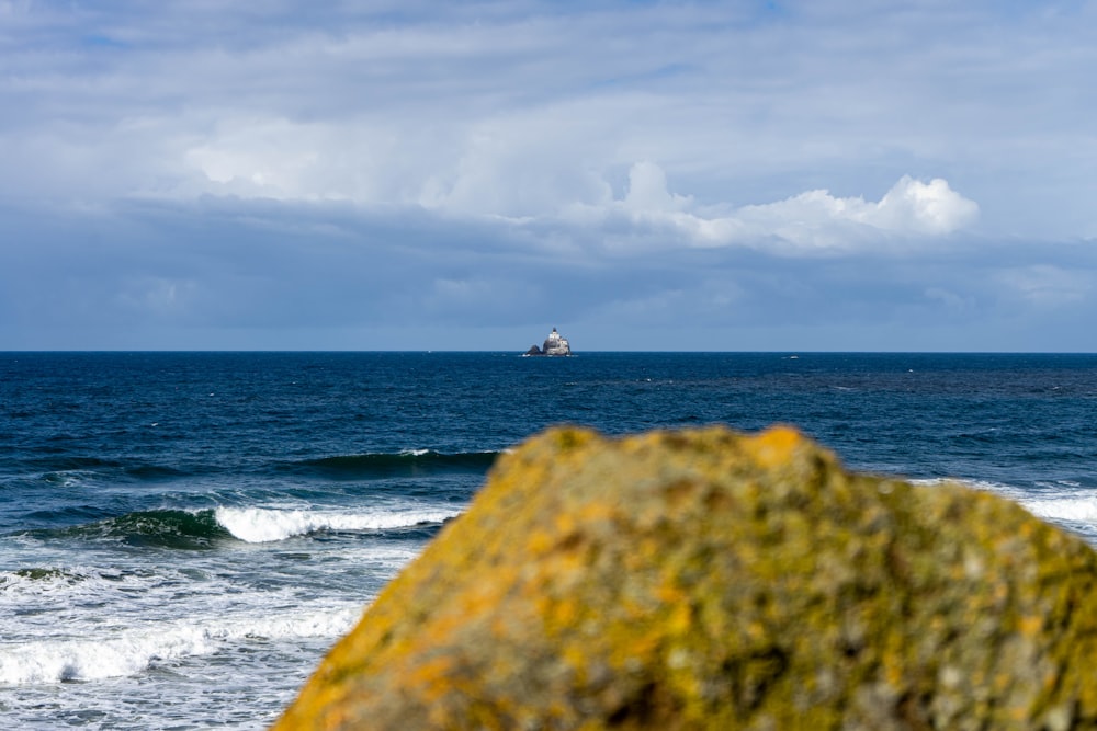 a boat out in the ocean on a cloudy day