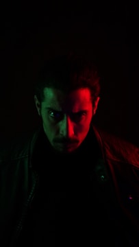 Close-up of an intense theatrical performance with moody lighting.