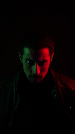 A cinematic portrait of a focused creator in a dimly lit studio, bathed in neon green light, symbolizing elite influencer partnership.