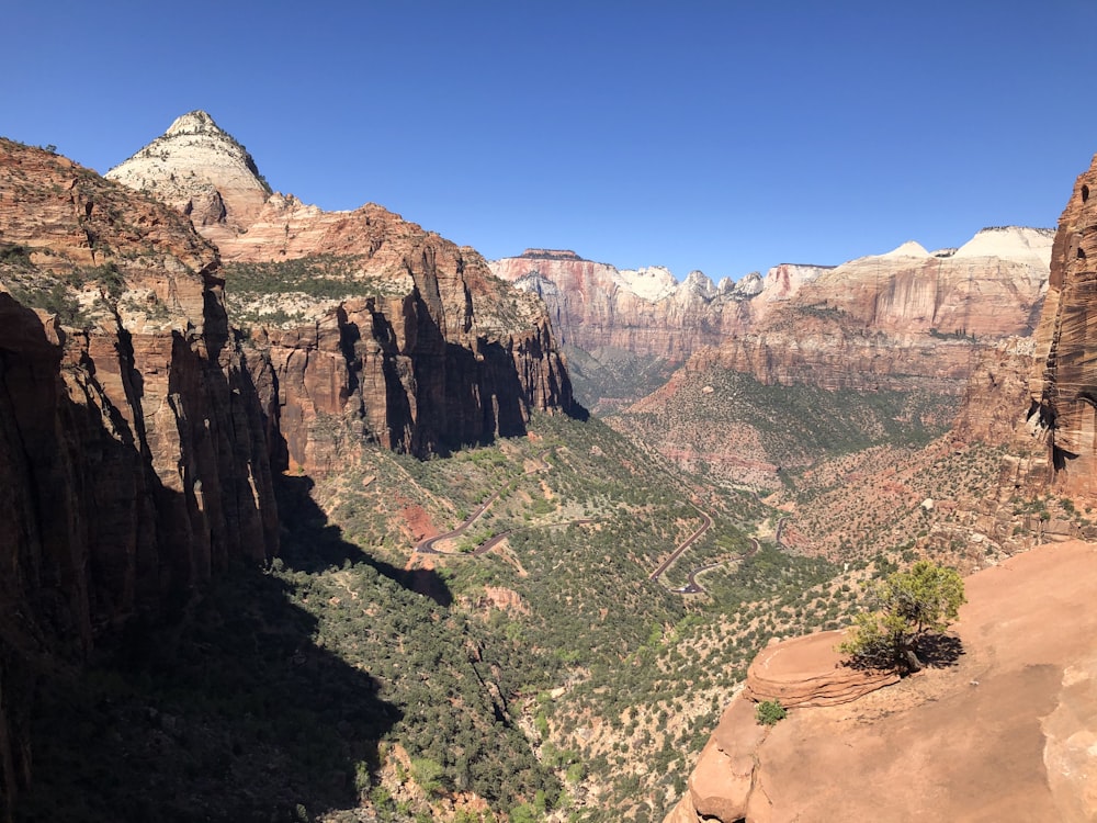 a scenic view of a canyon with mountains in the background