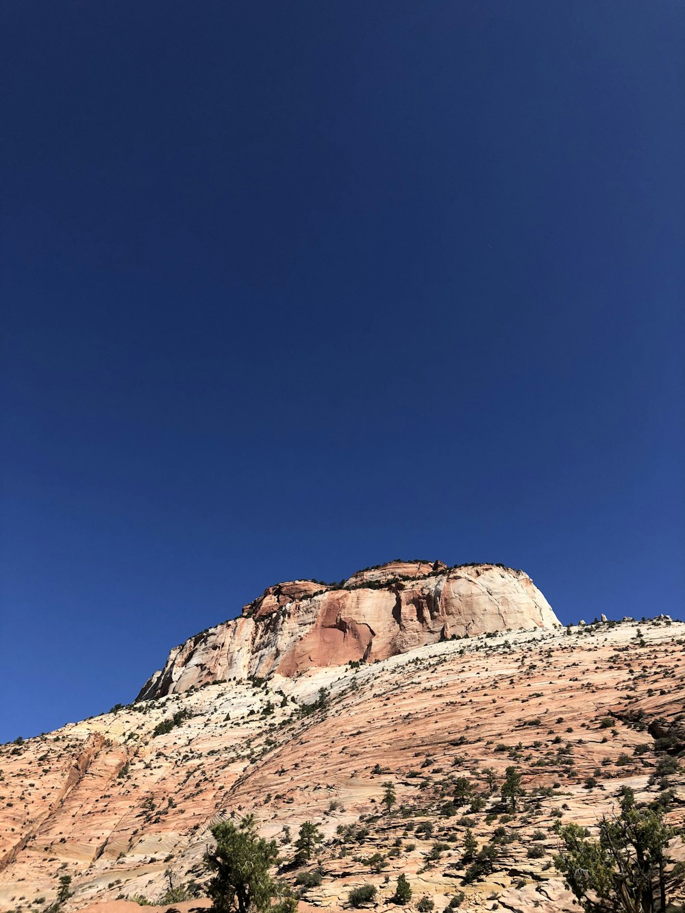 a mountain with a blue sky in the background