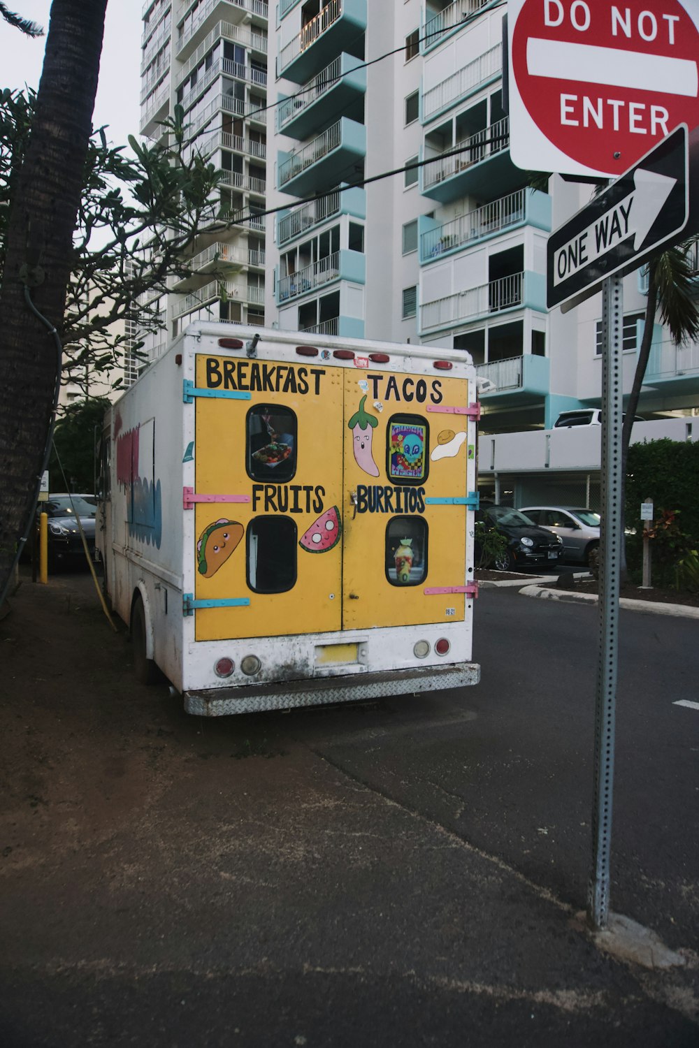 a food truck parked next to a do not enter sign