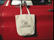 a bag hanging on the side of a red car