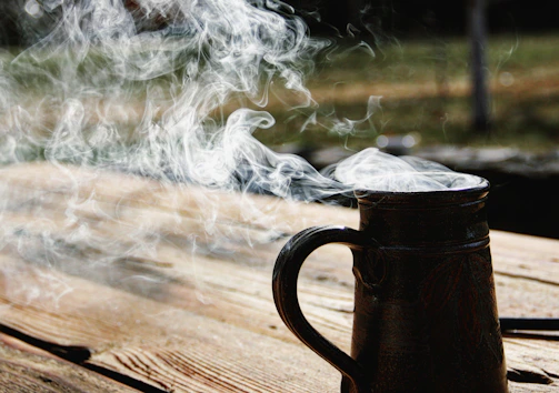 Freshly brewed coffee in a rustic mug with steam rising gently