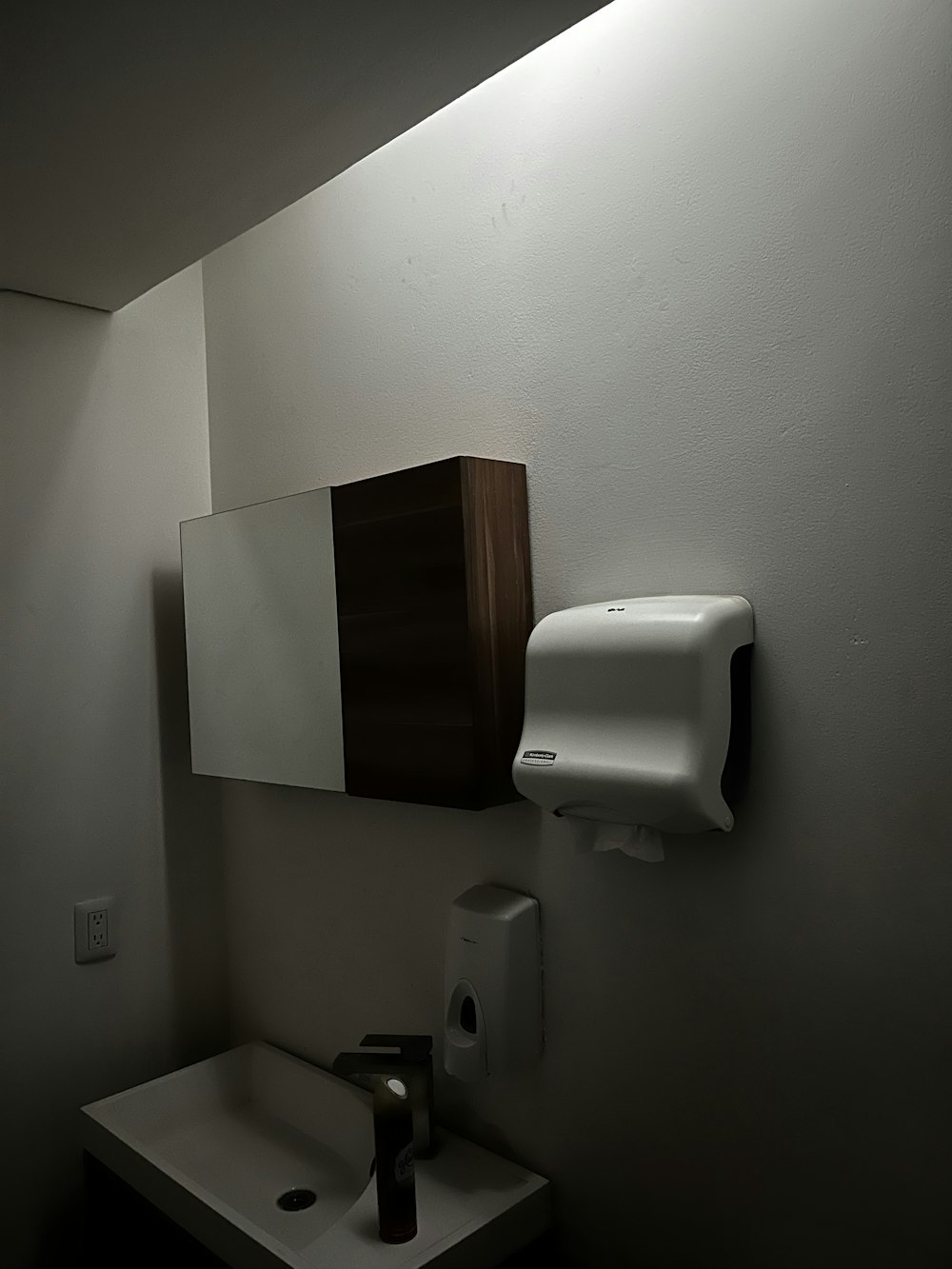 a bathroom with a white sink and a white urinal