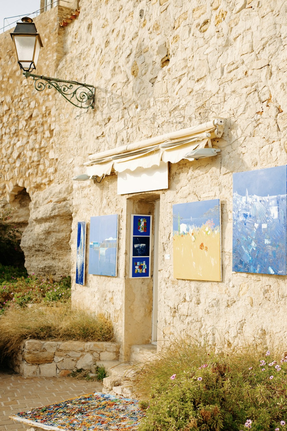 a stone building with paintings on the side of it