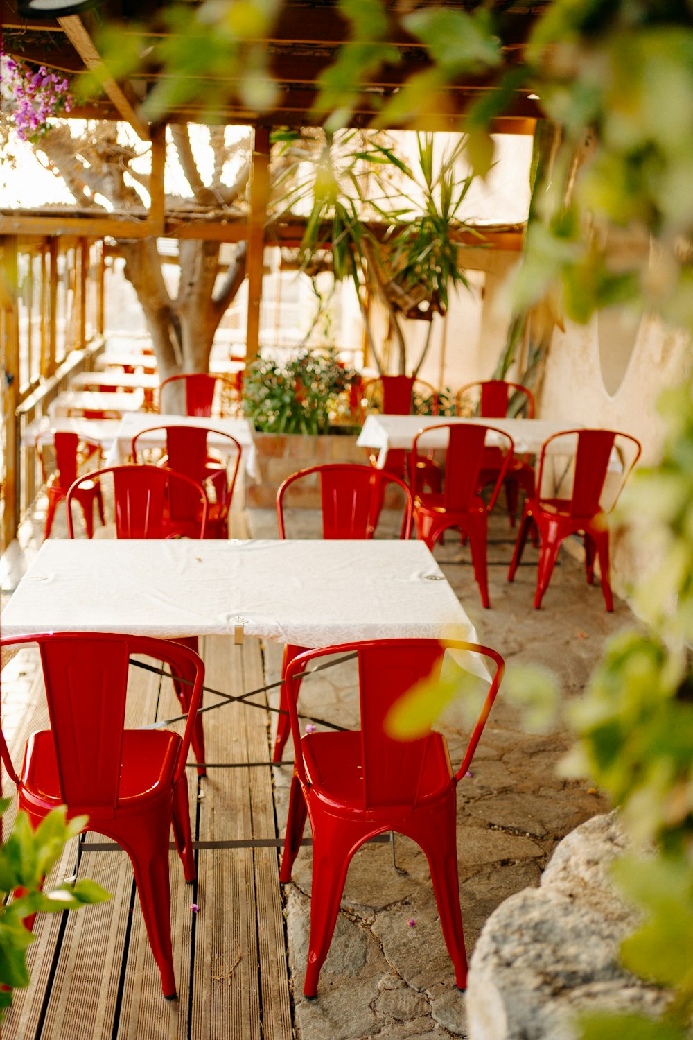 a table with red chairs and a white table cloth