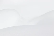 a man riding skis down a snow covered slope