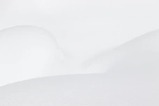 a man riding skis down a snow covered slope