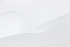 a man riding skis down a snow covered slope