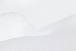 a man riding skis down a snow covered slope
