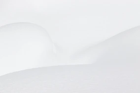 a man riding skis down a snow covered slope