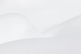 a man riding skis down a snow covered slope