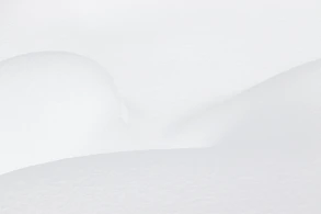 a man riding skis down a snow covered slope