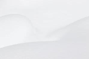 a man riding skis down a snow covered slope