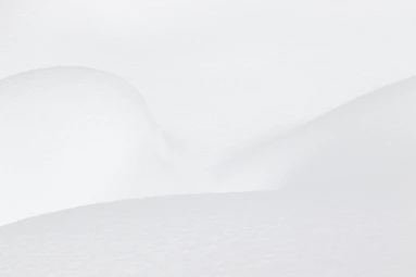a man riding skis down a snow covered slope