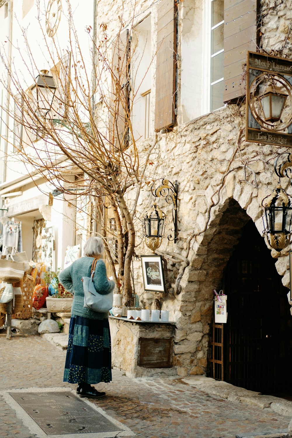 a woman standing in front of a stone building