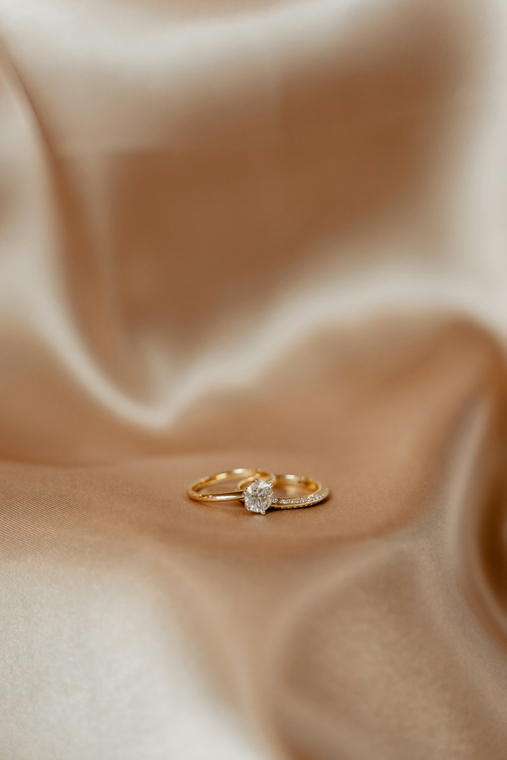a close up of a gold ring with a diamond