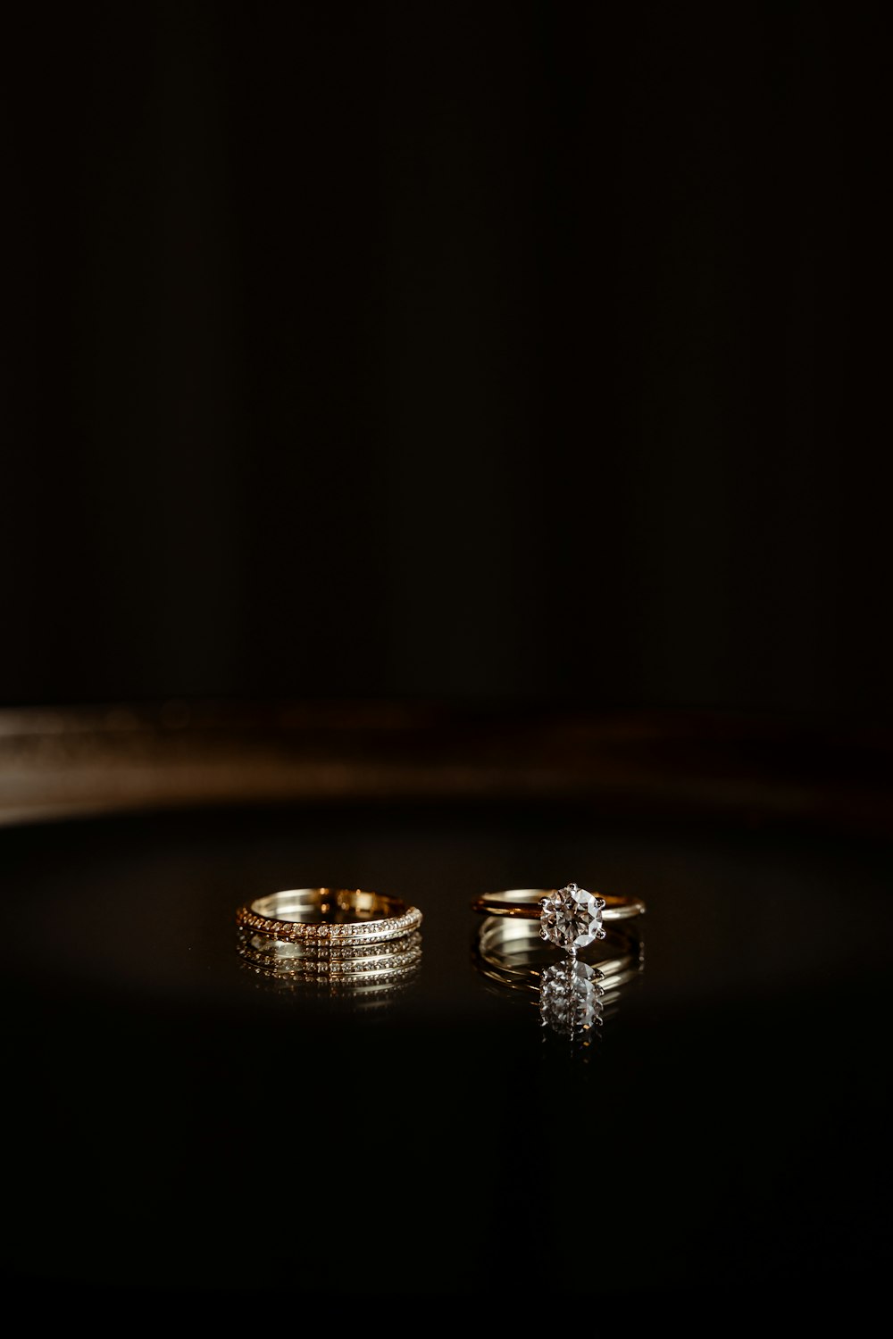 a couple of wedding rings sitting on top of a table