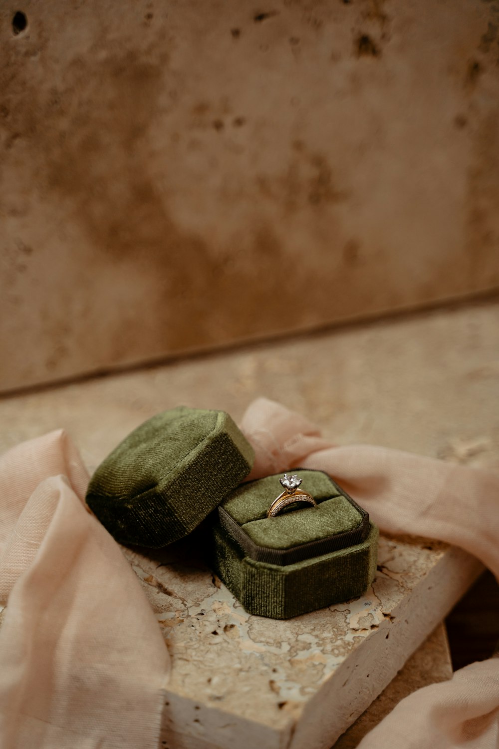 a couple of rings sitting on top of a piece of wood