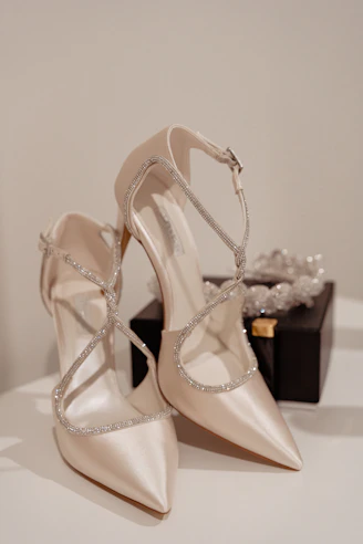 a pair of wedding shoes sitting on top of a table