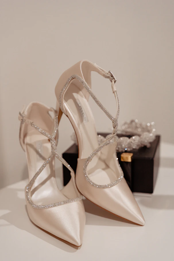 a pair of wedding shoes sitting on top of a table