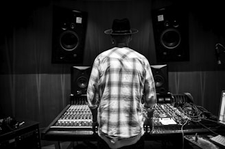 a man standing in front of a mixing desk