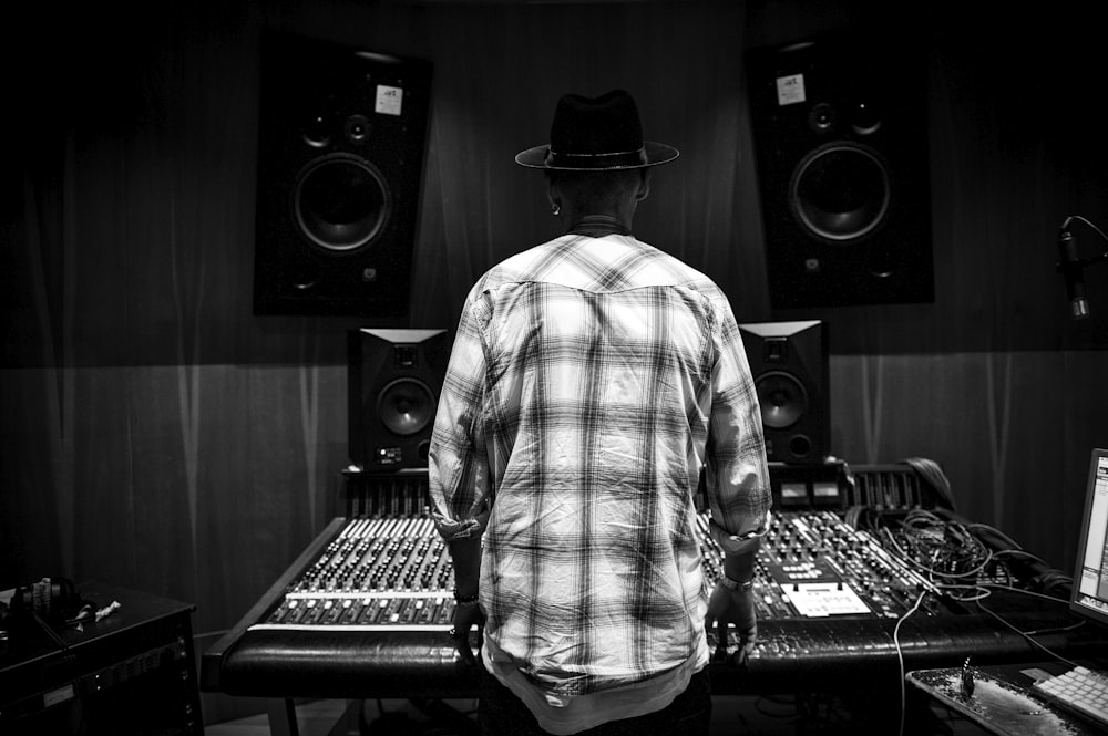 a man standing in front of a mixing desk