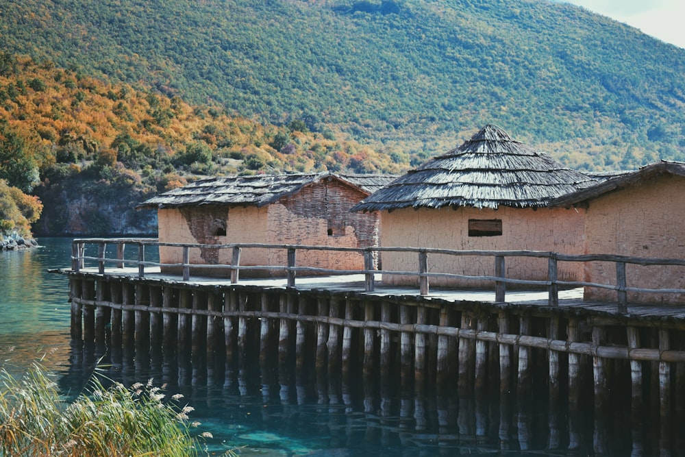 a wooden pier next to a body of water