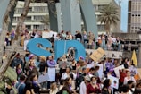 A large group of people, predominantly women, are gathered for a protest or rally. They are holding signs with various messages, many of which focus on women's rights and empowerment. Some participants are wearing purple, a color often associated with feminist movements. The atmosphere is lively and engaged, with a sense of solidarity among the crowd.
