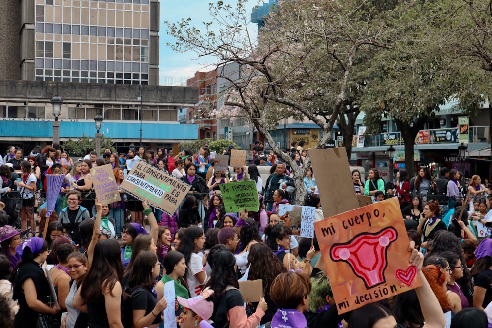 a large group of people holding up signs