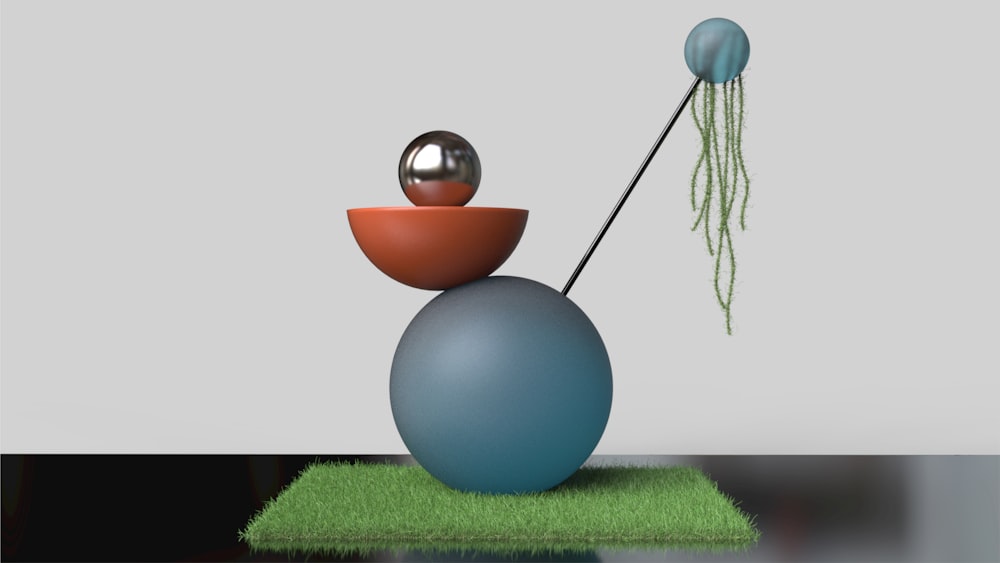 a blue vase with two balls and a string attached to it
