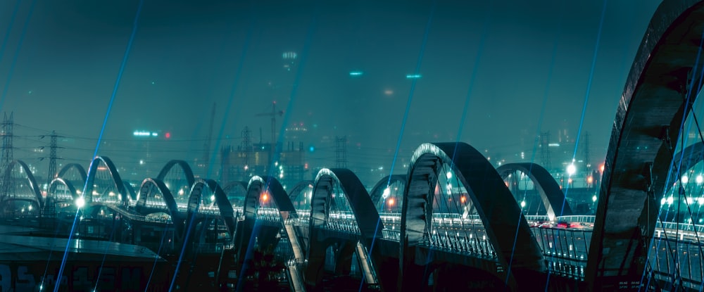 a night scene of a city with a bridge