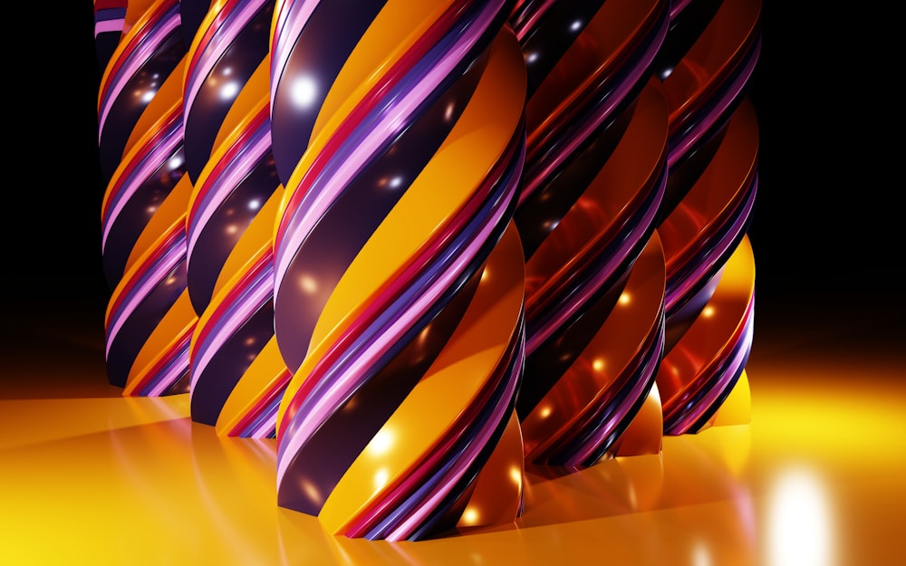 a group of colorful striped vases sitting on top of a table