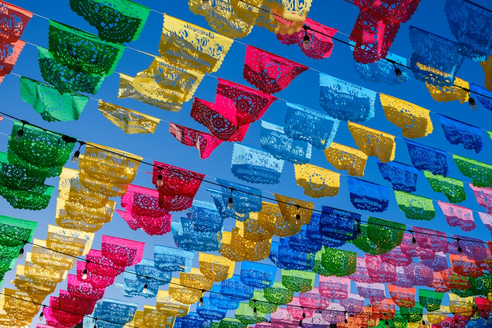 a bunch of colorful items hanging from a line