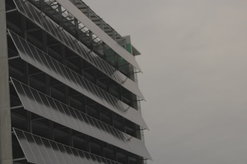 Solar panels gleaming under the sun atop a modern eco-friendly building.