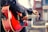 A vibrant image of a person strumming a nylon-string guitar outdoors.