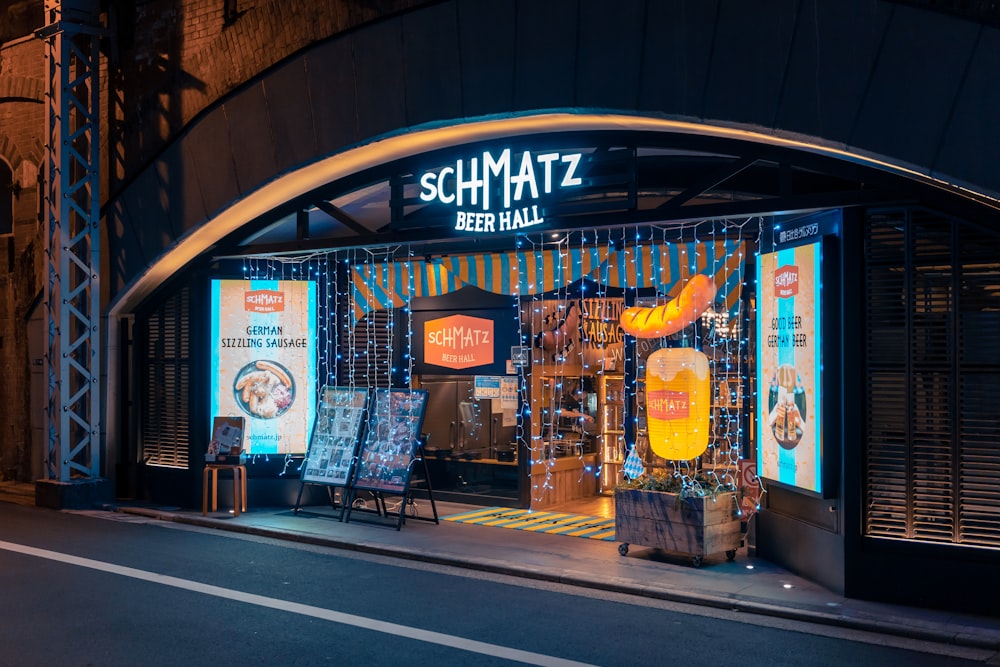 Un frente de tienda por la noche con luces de neón