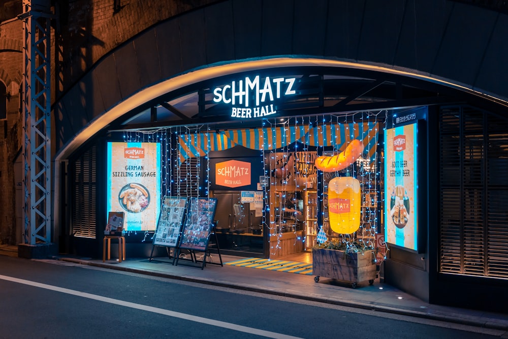 a store front at night with neon lights