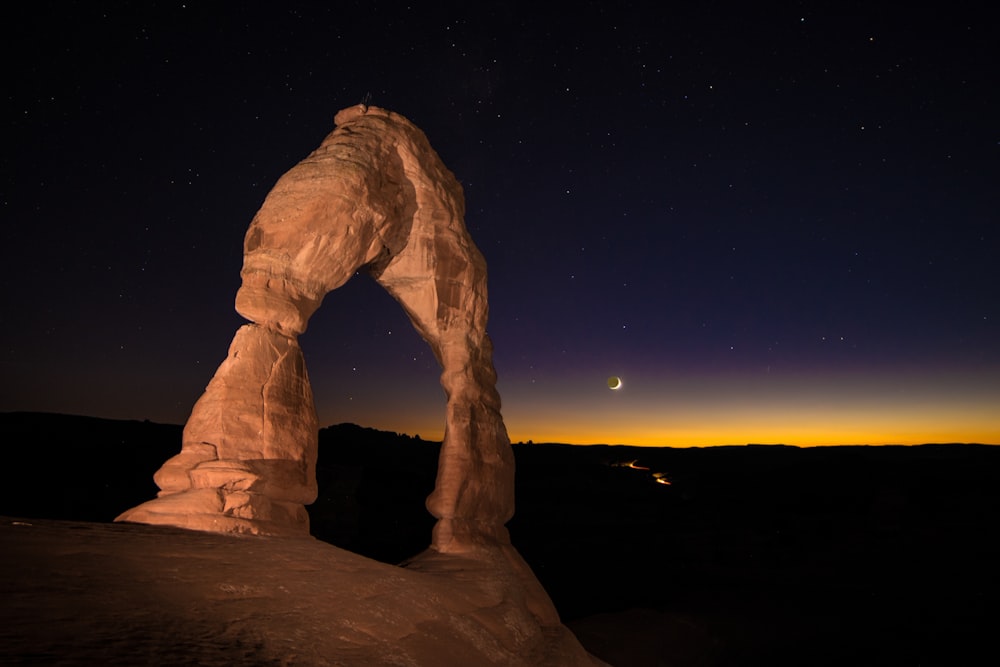a rock formation in the middle of a night sky