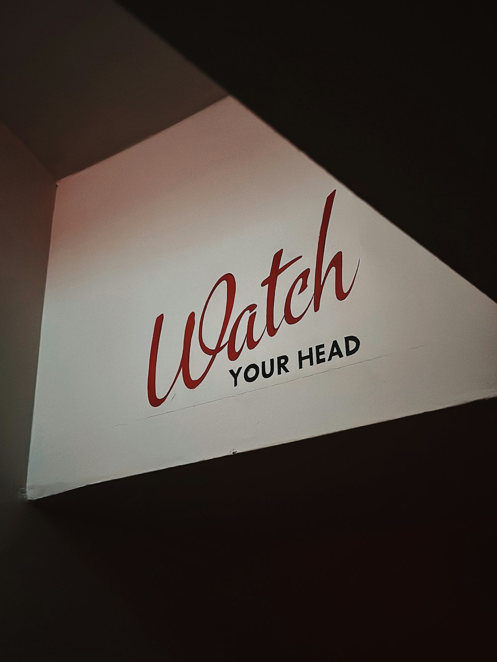 a close up of a sign that reads watch your head
