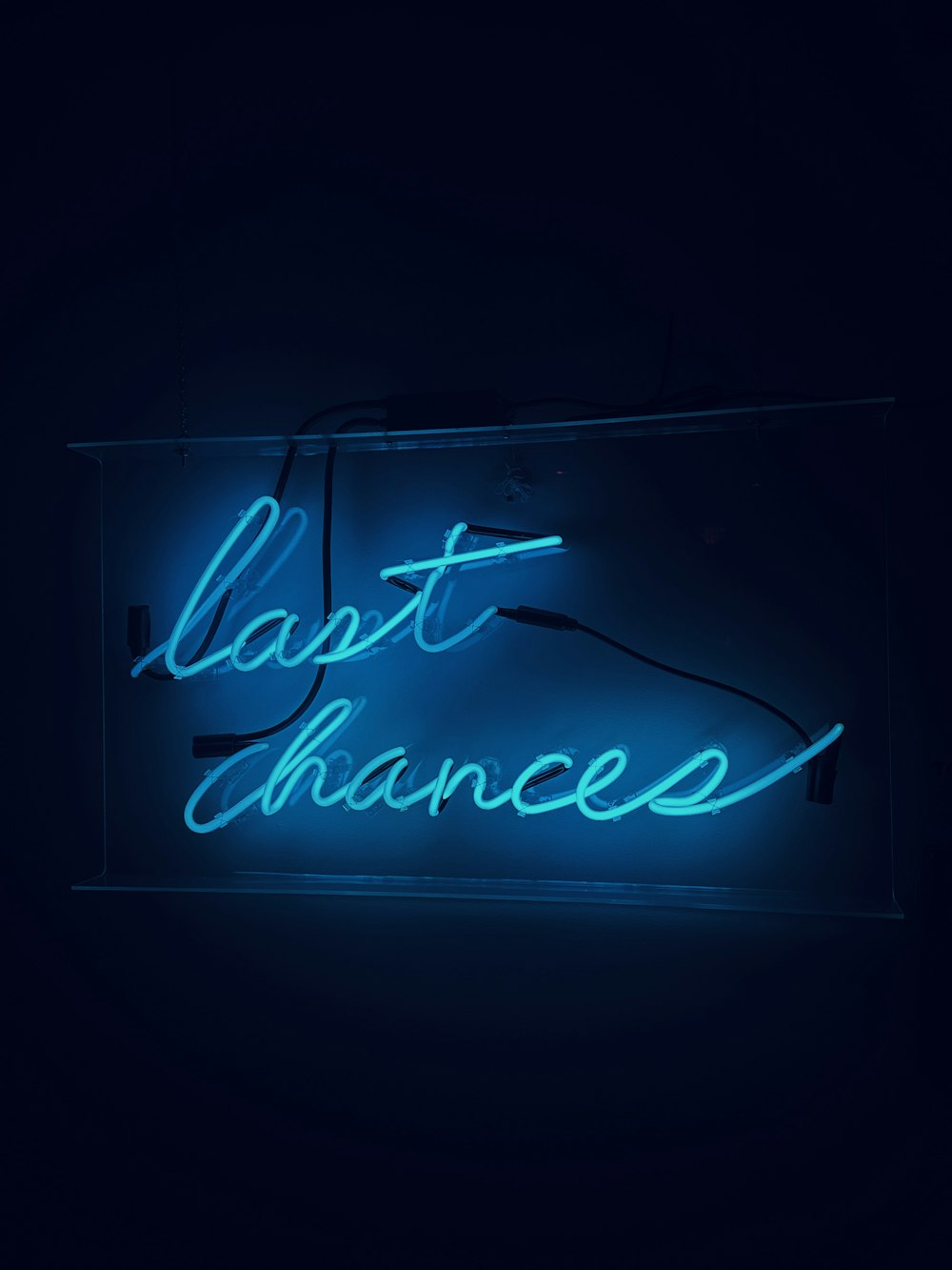 a neon sign that reads last chance