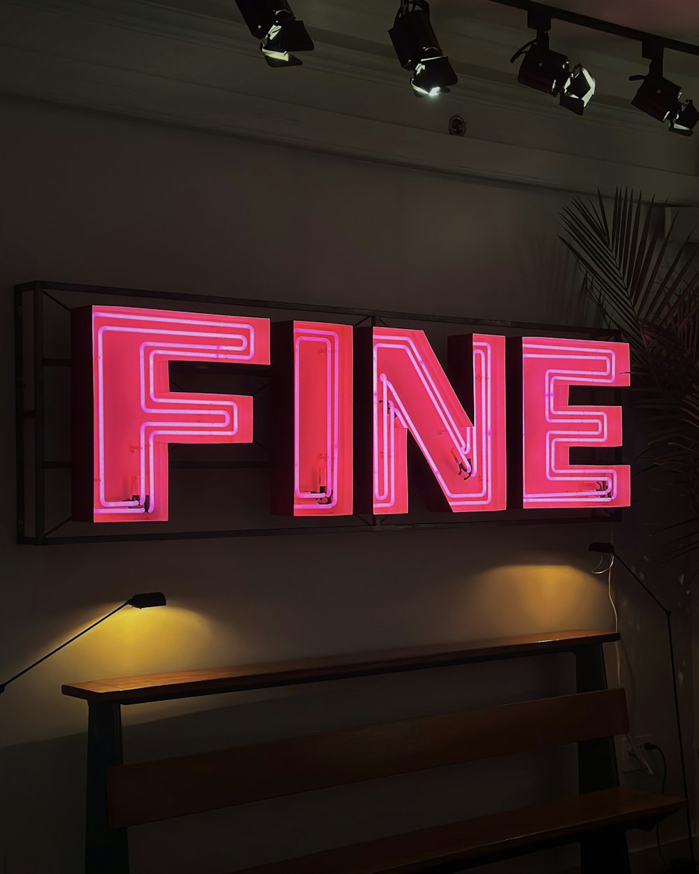 a neon sign that reads fine on a wall