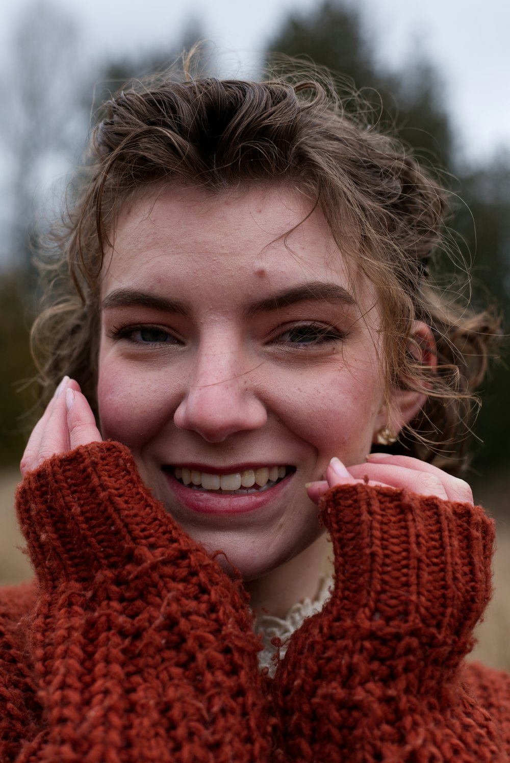 a woman in a red sweater is smiling