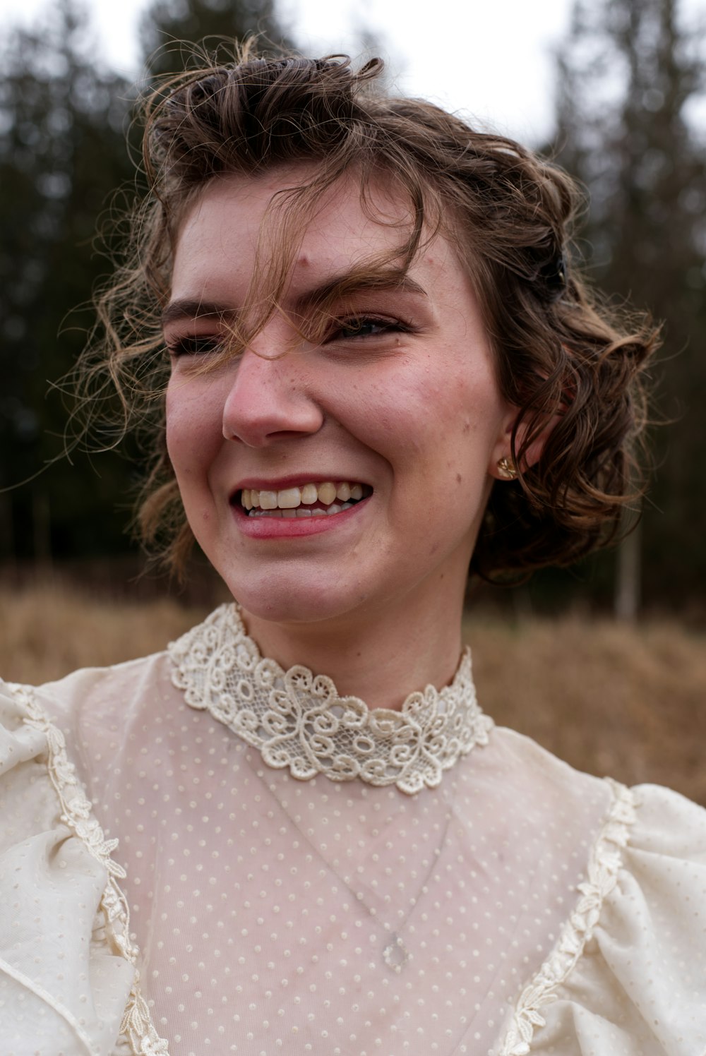 a close up of a person wearing a dress and smiling
