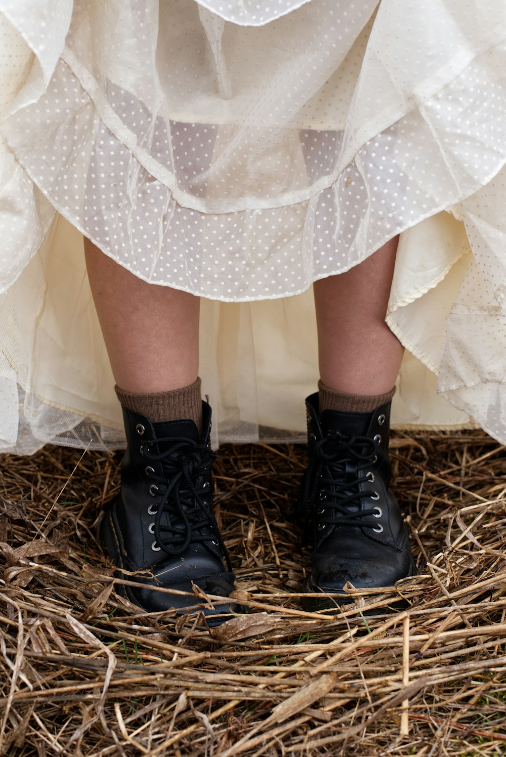 a close up of a person wearing black boots