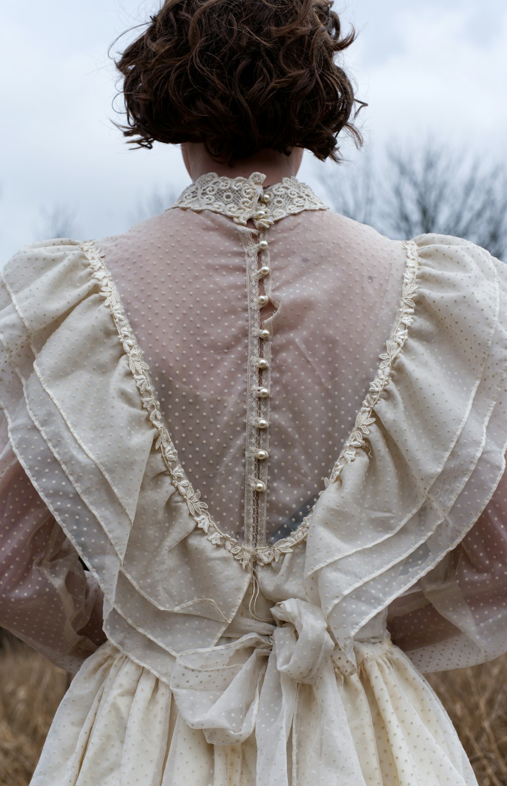the back of a woman's dress in a field