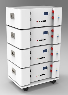 Array of compact controllers with digital displays on a workbench.